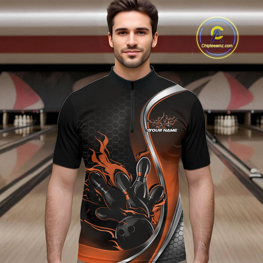 Male model front view in bowling alley wearing black and orange quarter zip shirt featuring flaming bowling ball striking pins dynamic artwork