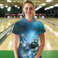 Load image into Gallery viewer, Female model wearing a blue bowling polo shirt at a bowling lane with butterfly artwork, a bowling ball, and scattered pin graphics.