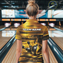 Load image into Gallery viewer, Back view of a female model at a bowling lane wearing a bowling quarter-zip shirt with glossy gold and black bowling ball and pins artwork.