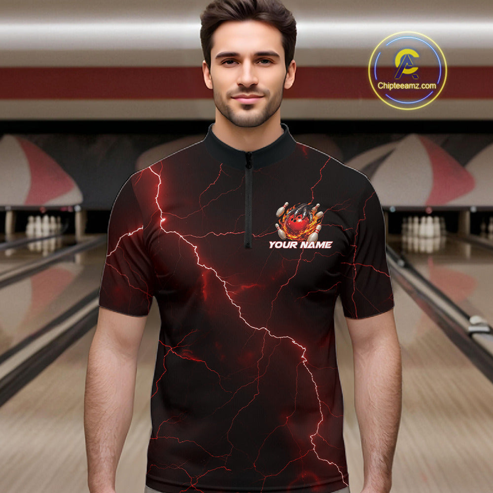 Male model at the bowling lane wearing a black and red quarter-zip with dragon claw artwork and fiery bowling elements.