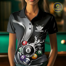 Load image into Gallery viewer, Front view of a female model wearing a black and silver billiard polo with metallic ribbon accents, a dark honeycomb pattern, and a flaming 8-ball surrounded by pool balls