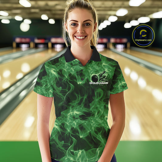 Female model wearing a green bowling polo in a bowling alley with flaming bowling ball graphics.