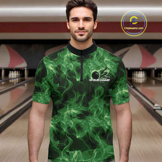 Male model wearing a green bowling quarter-zip in a bowling center with flaming bowling ball graphics.