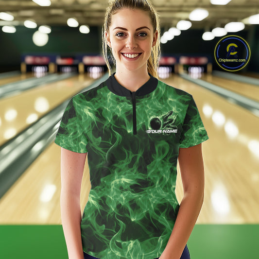 Female model wearing a green bowling quarter-zip in a bowling lane with flaming bowling ball artwork.