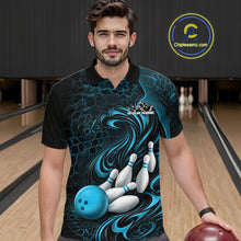 Load image into Gallery viewer, Male model standing in a bowling lane wearing a black and blue bowling polo shirt featuring a tribal flame bowling ball and pins graphic on the front.