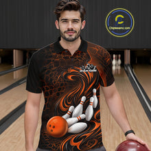Load image into Gallery viewer, Male model standing in a bowling lane wearing a black and orange bowling polo shirt featuring a tribal flame design with a bowling ball and pins on the front.