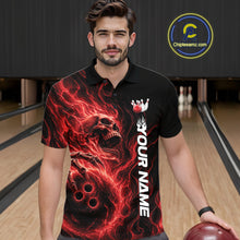 Load image into Gallery viewer, Male model wearing a black bowling polo shirt in a bowling alley featuring a skull clutching a bowling ball surrounded by swirling red energy flames