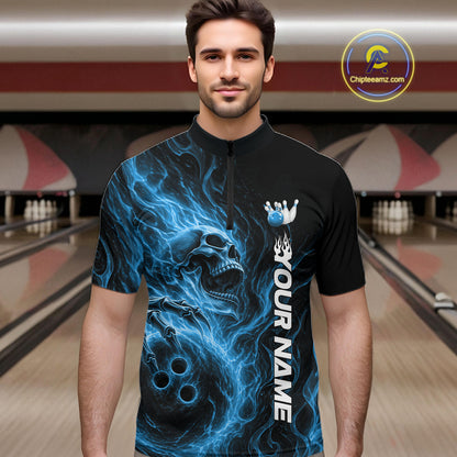 Male model wearing a black bowling quarter-zip shirt in a bowling alley featuring a skull clutching a bowling ball with swirling blue energy flames