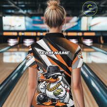 Load image into Gallery viewer, Back view of a female model in a black and orange bowling polo shirt at a bowling lane featuring a duck-themed bowling graphic with pins and ball.