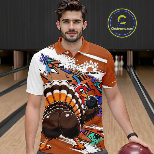 Front view of a male model wearing an orange custom bowling polo shirt featuring a funny graffiti style turkey holding a bowling ball, paint splatter details, and a custom name in a bowling alley.