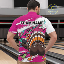 Load image into Gallery viewer, Back view of a male model in a bowling alley wearing a pink custom quarter zip bowling shirt with a funny graffiti turkey holding a bowling ball, paint splatter accents, and a personalized name.