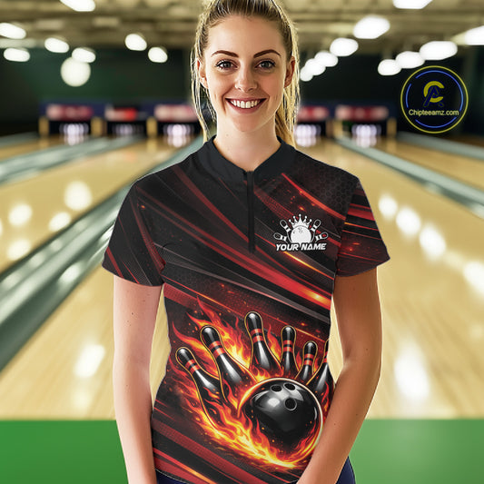 Female model in a bowling lane wearing black and red orange quarter zip shirt, front view showcasing fiery bowling ball hitting pins dynamic illustration