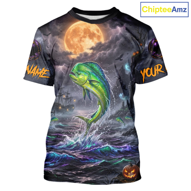A short-sleeve crewneck t-shirt featuring a full-bleed Halloween graphic print. The design depicts a green and yellow mahi-mahi fish jumping from dark, stormy ocean waves under a large orange full moon, with a ghost ship in the background and customizable text placeholders 'NAME' and 'YOUR' on the sleeves.