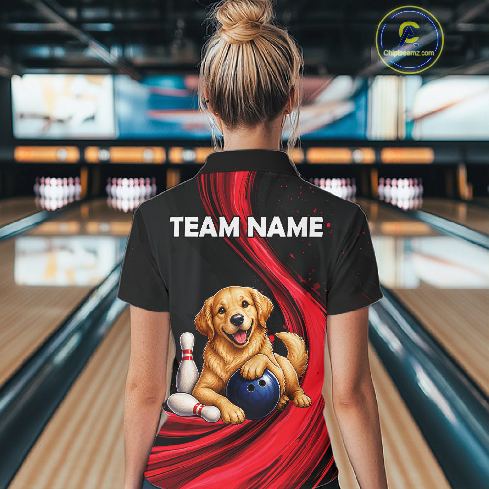 A woman viewed from behind wearing a black short-sleeve bowling shirt with a large back graphic showing a golden retriever puppy holding a bowling ball on a red swoosh design. The shirt has 'TEAM NAME' printed in white across the upper back.