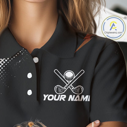 A close-up of a person wearing a black polo shirt with a white golf-themed graphic on the chest featuring crossed golf clubs, a golf ball, and the placeholder text 'YOUR NAME'.