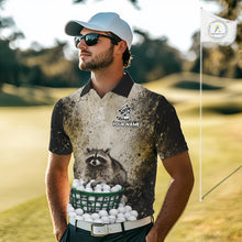 Load image into Gallery viewer, Man wearing a golf-themed shirt with a raccoon design on a golf course