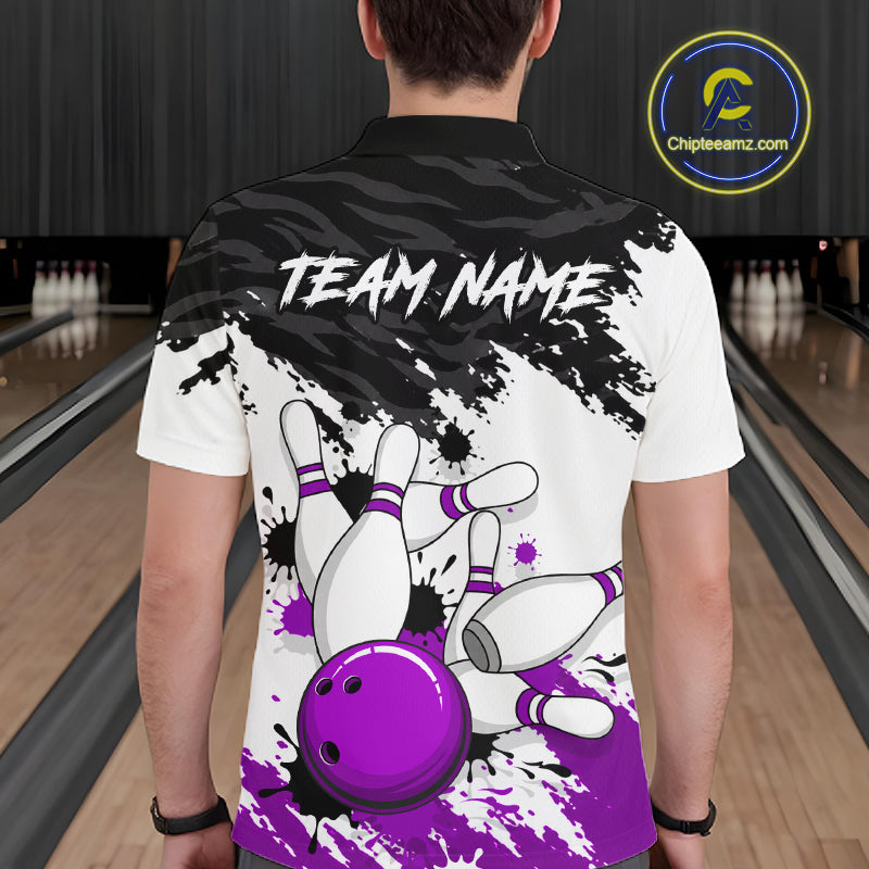 A person viewed from behind wearing a white short-sleeve bowling-themed polo shirt with a black and purple graphic print of bowling pins and a bowling ball, plus the text 'TEAM NAME' across the upper back. The background shows a blurred bowling alley interior, and a circular 'Chipteeamz.