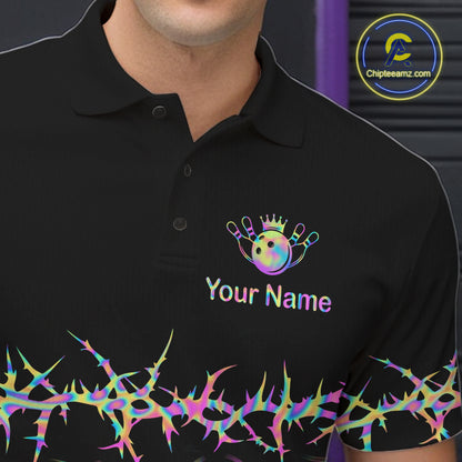 A close-up of a black polo shirt worn by a model, featuring a colorful bowling-themed graphic with a crown, pins, and the text 'Your Name' on the left chest, plus a matching thorny pattern along the hem. A circular 'Chipteeamz.