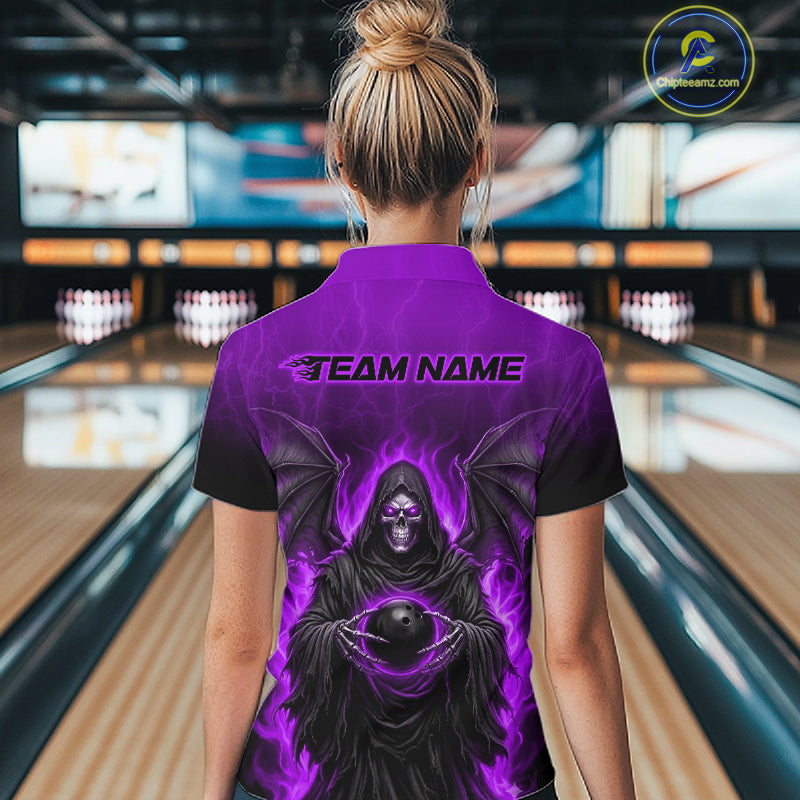 A woman viewed from behind wearing a purple and black bowling-themed polo shirt with a grim reaper graphic and 'TEAM NAME' printed on the back, standing in a bowling alley.