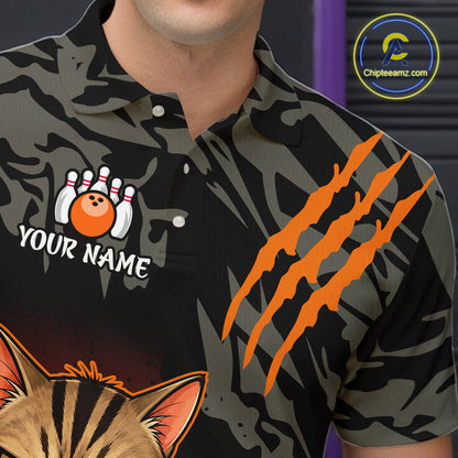 A close-up of a person wearing a short-sleeve polo shirt with a dark camouflage pattern, orange claw marks, a bowling pin and ball graphic with the text 'YOUR NAME', and part of a cat face at the bottom. A circular 'Chipteeamz.