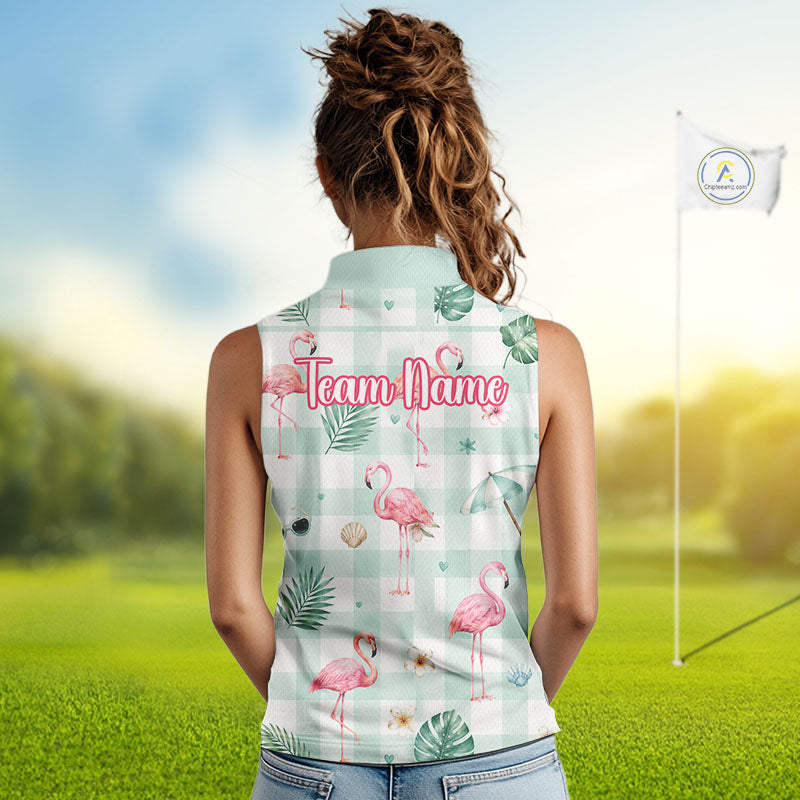 A woman viewed from behind wearing a sleeveless collared golf shirt with a pink flamingo and tropical leaf print on a white gingham background. The shirt features the text 'Team Name' in pink script across the upper back.