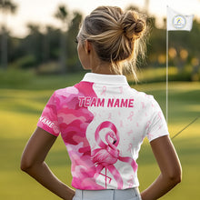 Load image into Gallery viewer, A woman wearing a Breast Cancer Awareness pink ribbon golf polo shirt, with team name on the back and standing in the golf course.
