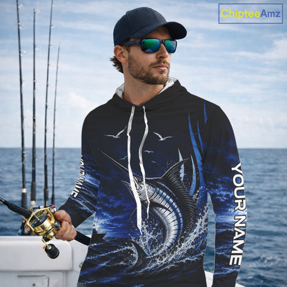 Angler wearing personalized Blue Marlin blue long sleeve hooded performance fishing shirt on the water