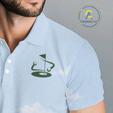 Load image into Gallery viewer, Light blue polo shirt with a green logo on a background