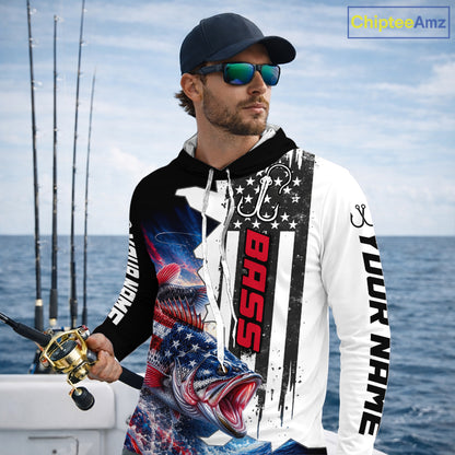 Angler wearing custom American flag bass patriotic black camo long sleeve hooded fishing shirt on the water 