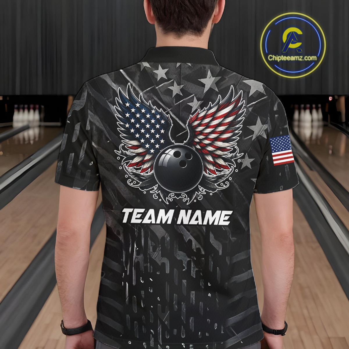 Back view of man wearing a black American flag wings bowling quarter zip shirt in a bowling alley.