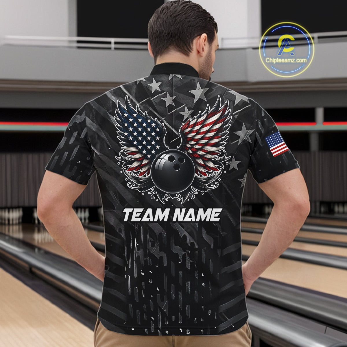 Back view of man wearing a black American flag wings bowling polo shirt inside a bowling alley.