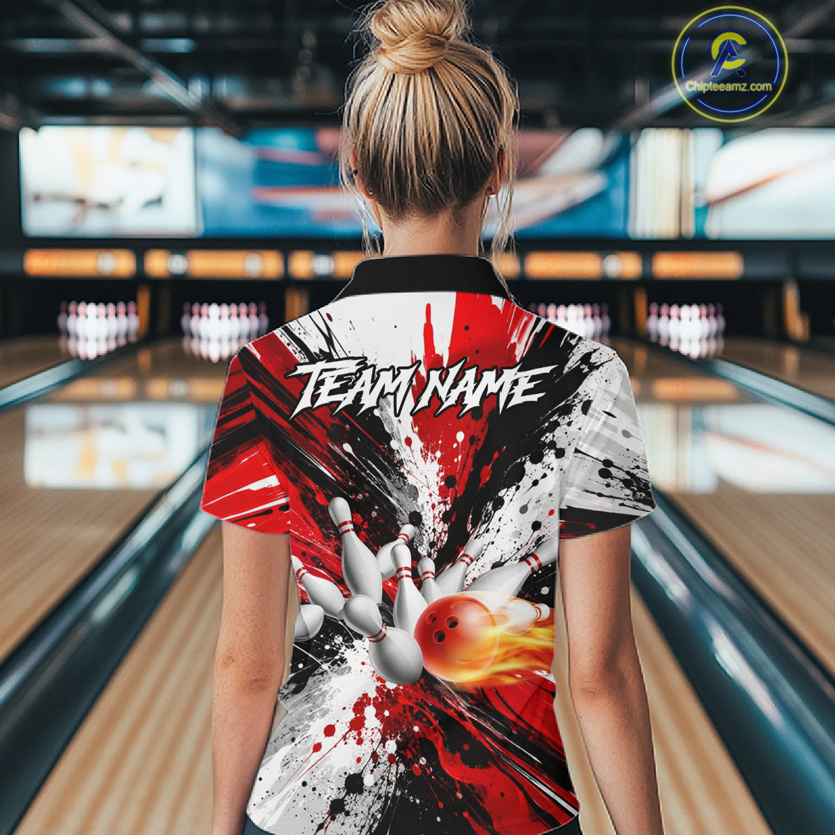 Back view of woman wearing a red splatter bowling polo shirt inside a bowling alley.