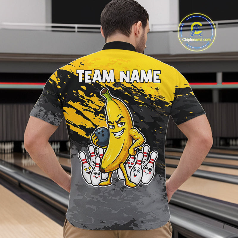 Back view of man wearing a yellow funny banana bowling quarter zip shirt in a bowling alley.