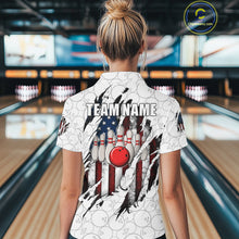 Load image into Gallery viewer, Back view of woman wearing a vintage American flag white bowling polo shirt inside a bowling alley.