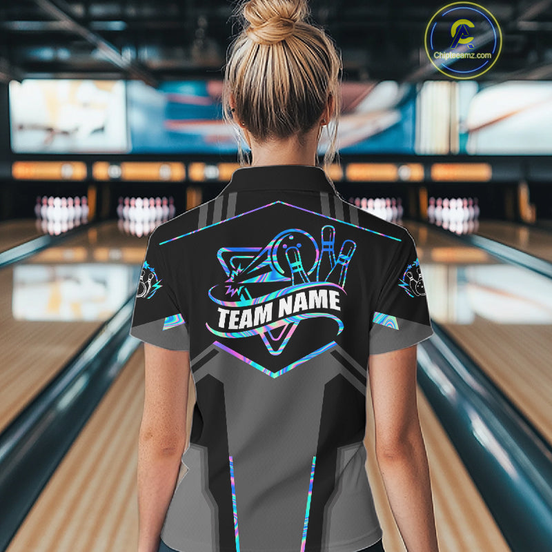 Back view of woman wearing a holographic bowling polo shirt inside a bowling alley.