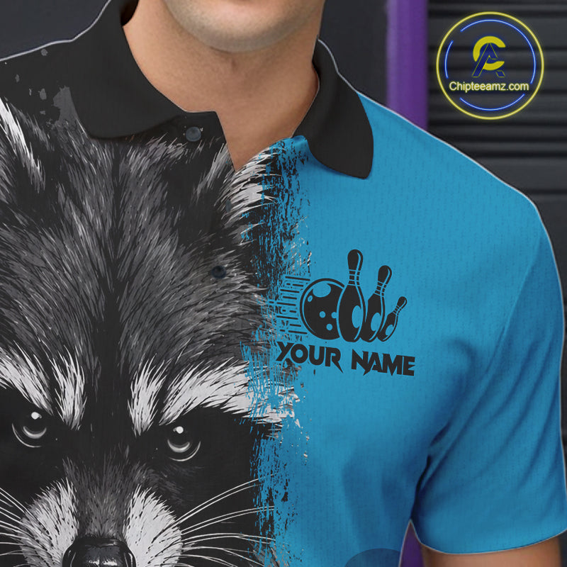 Close-up of a black and blue raccoon bowling polo shirt collar, buttons, and raccoon artwork details.