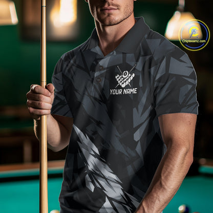 Man wearing a black and grey billiard jersey beside a pool table front view.