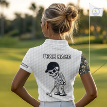 Load image into Gallery viewer, Female golfer wearing tropical skull golf polo on sunny golf course, fashionable golf apparel representing freedom, nature and resort living.