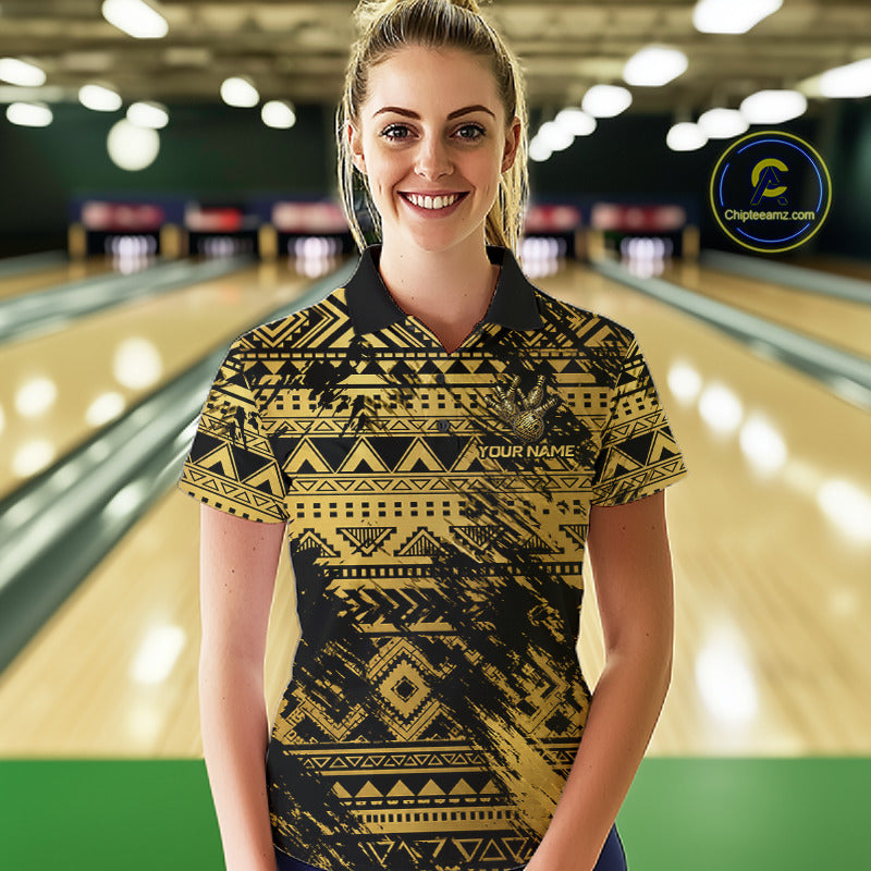 Female bowler posing confidently inside a modern bowling alley wearing Gold Tribal bowling jersey, Hawaiian-inspired sportswear, Polynesian heritage, warrior spirit, courage, resilience, championship mindset, personalized bowling apparel.